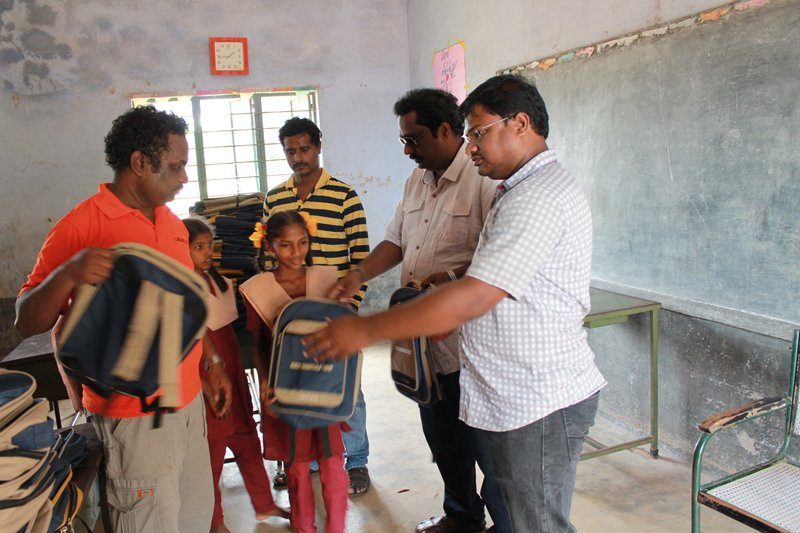 Raviraj, Sathya and Anand of seeds distributing the kit to the students